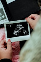 a person holding a picture of a baby's diaper