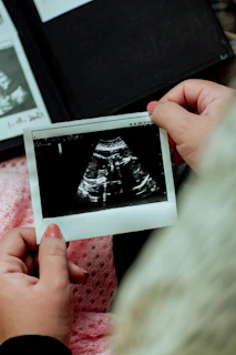 a person holding a picture of a baby's diaper
