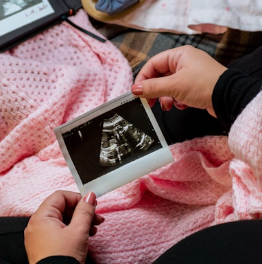 a person is holding a picture of a baby