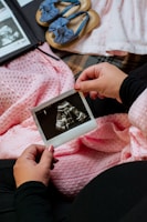 a person is holding a picture of a baby