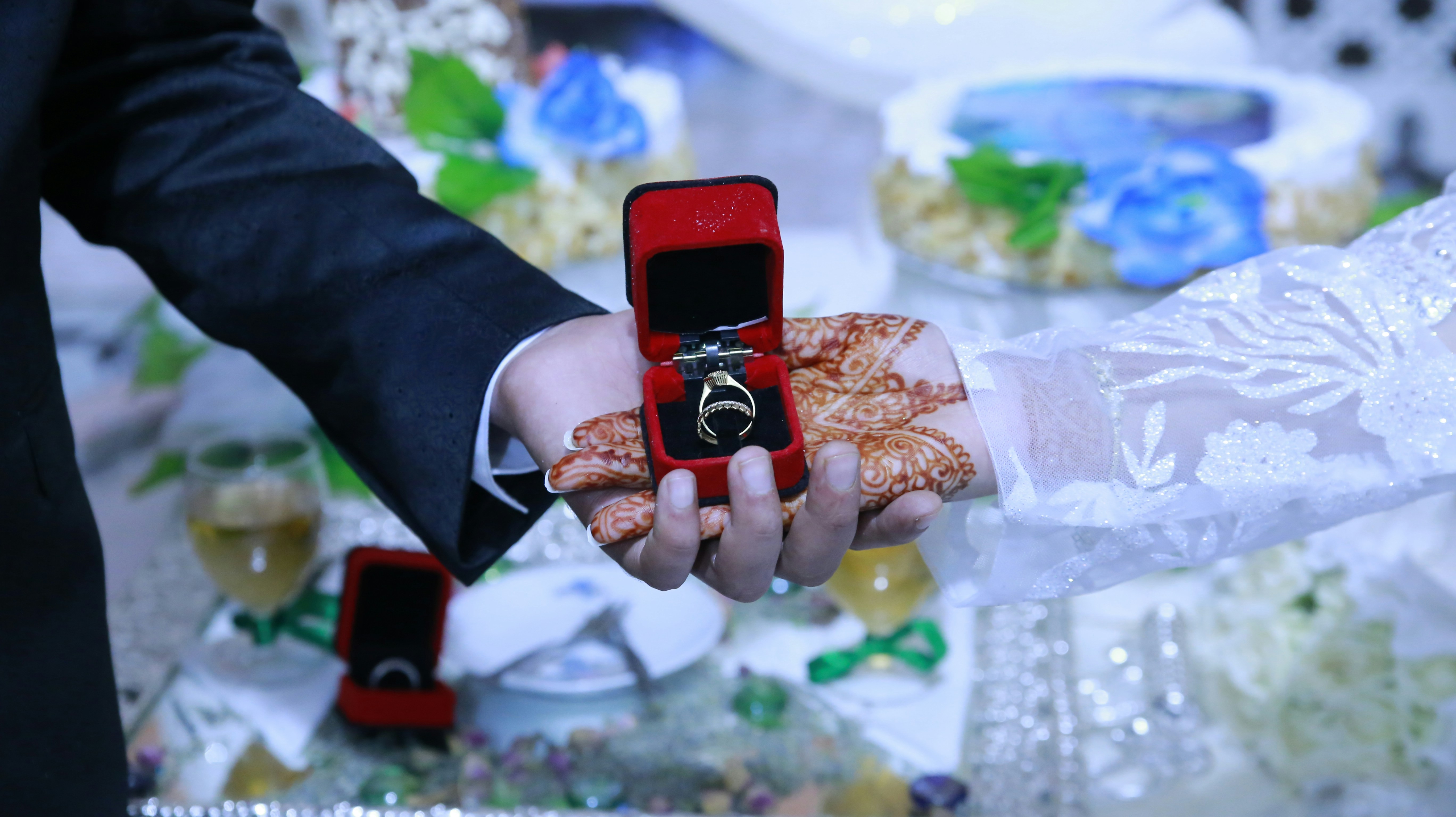 a person holding a red ring in their hand