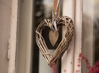 a heart shaped wreath hanging on a door