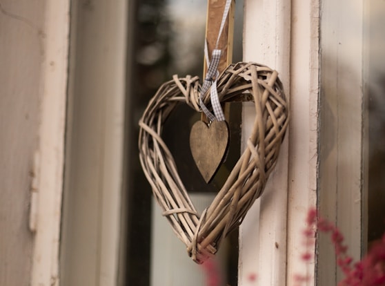 a heart shaped wreath hanging on a door
