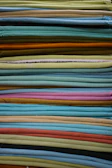 Neatly folded garments showcasing varied fabric textures and patterns.