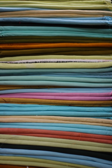Close-up of bright, patterned fabric wipes neatly stacked with visible stitching details