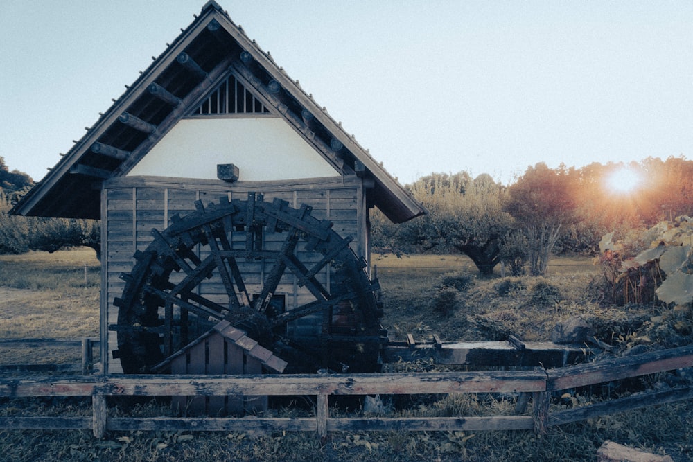 a building with a water wheel in front of it