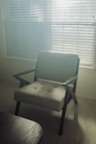 Calm therapy room with soft natural light and a comfortable chair for relaxation sessions.