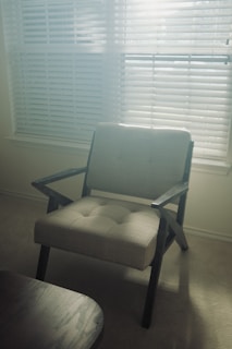 Bright and cozy counseling office interior with comfortable beige armchairs and warm sunlight.