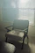 Gentle sunlight filtering through a cozy therapy room window with soft cushions on a chair.
