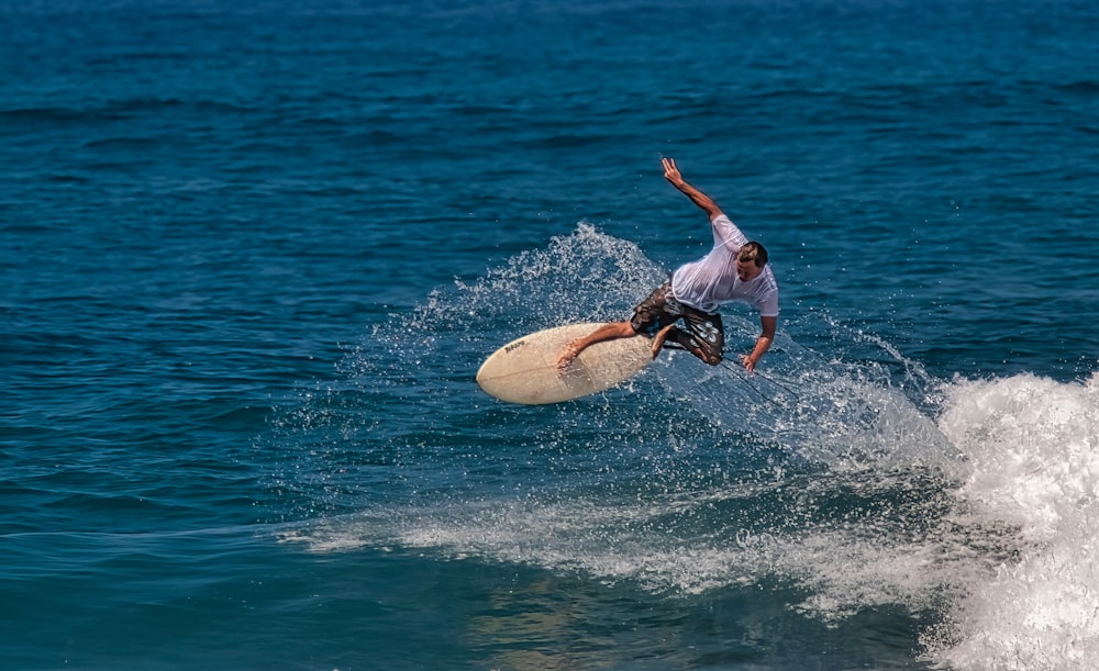 a man riding a wave on top of a surfboard