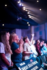 a group of people standing in front of a crowd of people