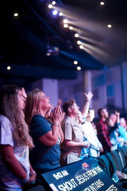 a group of people standing in front of a crowd of people