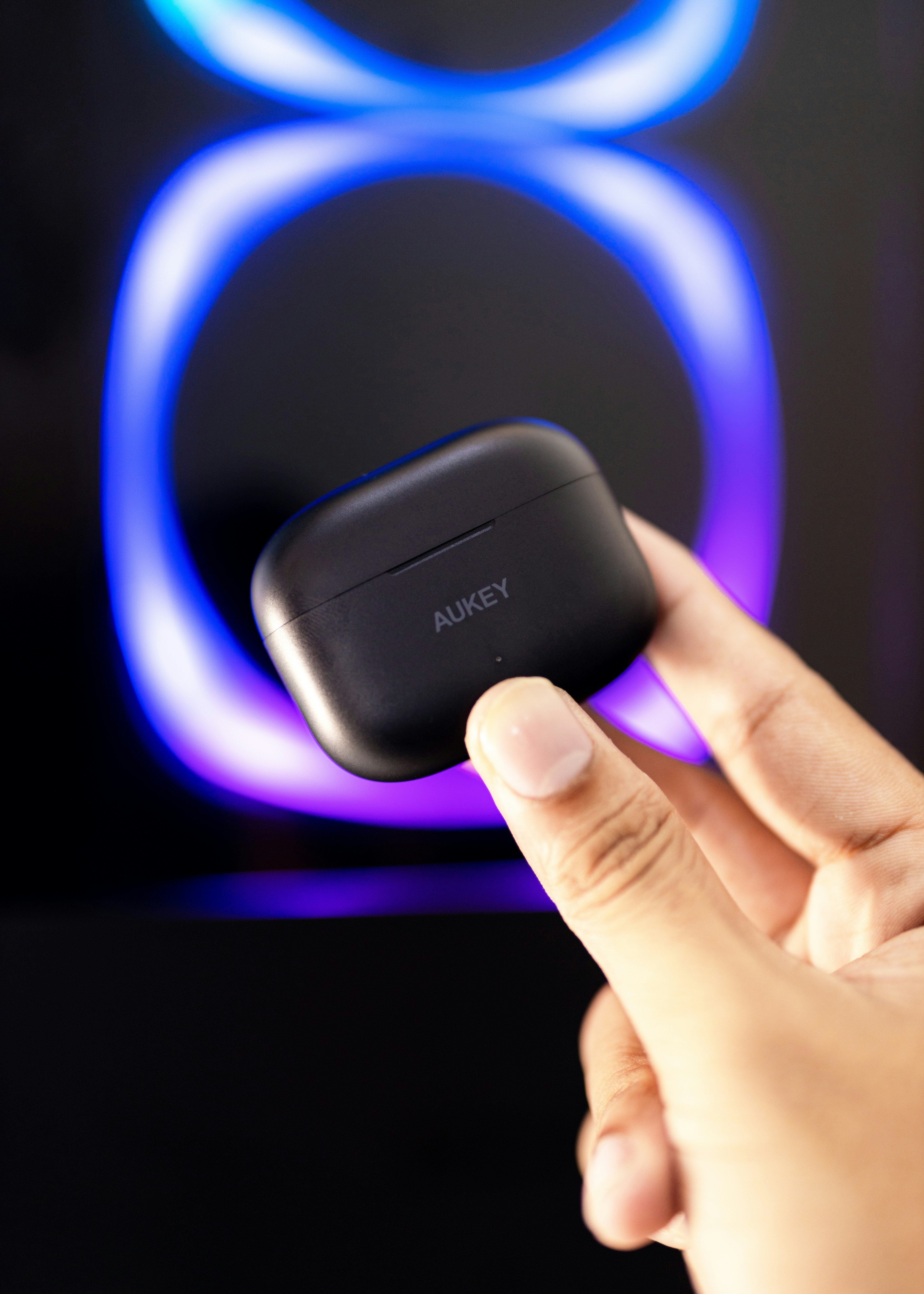 a person holding a small device in their hand