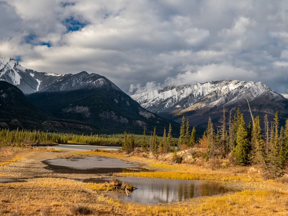 a mountain range with a lake in the foreground