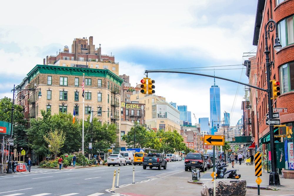 a city street filled with traffic next to tall buildings