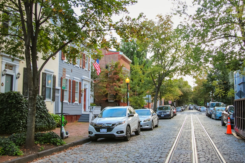 a street lined with parked cars and trees