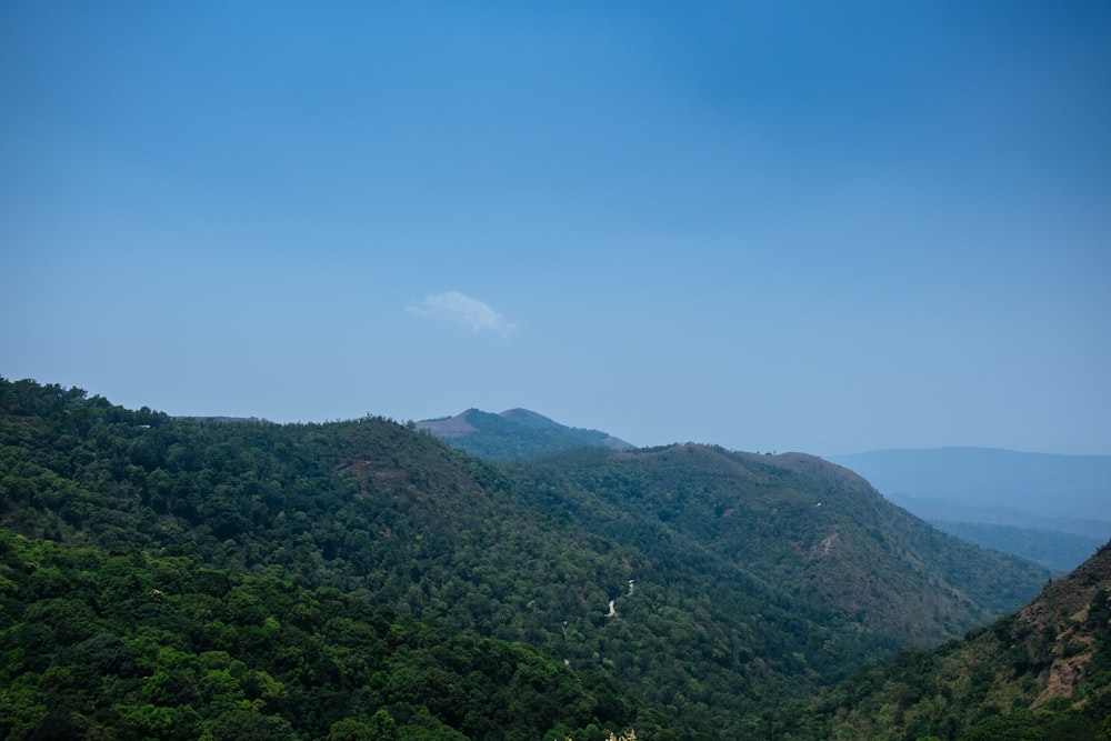 a view of a mountain range with trees and mountains in the background