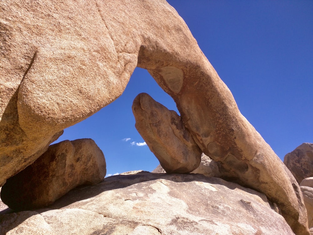 a rock formation with a blue sky in the background