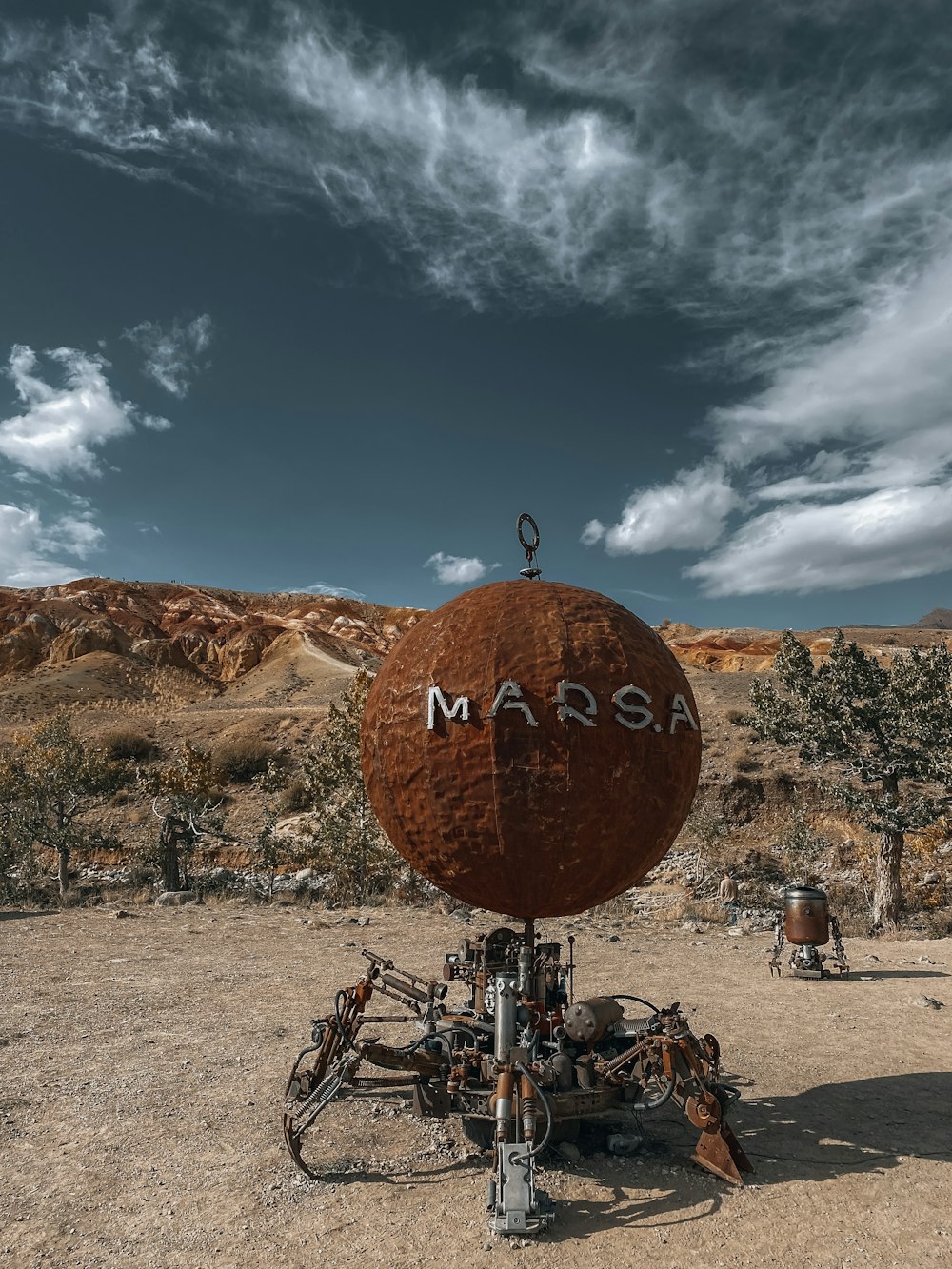 a large red object sitting in the middle of a desert