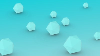 Several light blue polyhedral shapes are floating against a gradient turquoise background. The 3D geometric forms appear to be scattered randomly across the scene.