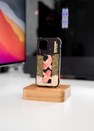 a phone case sitting on top of a wooden stand