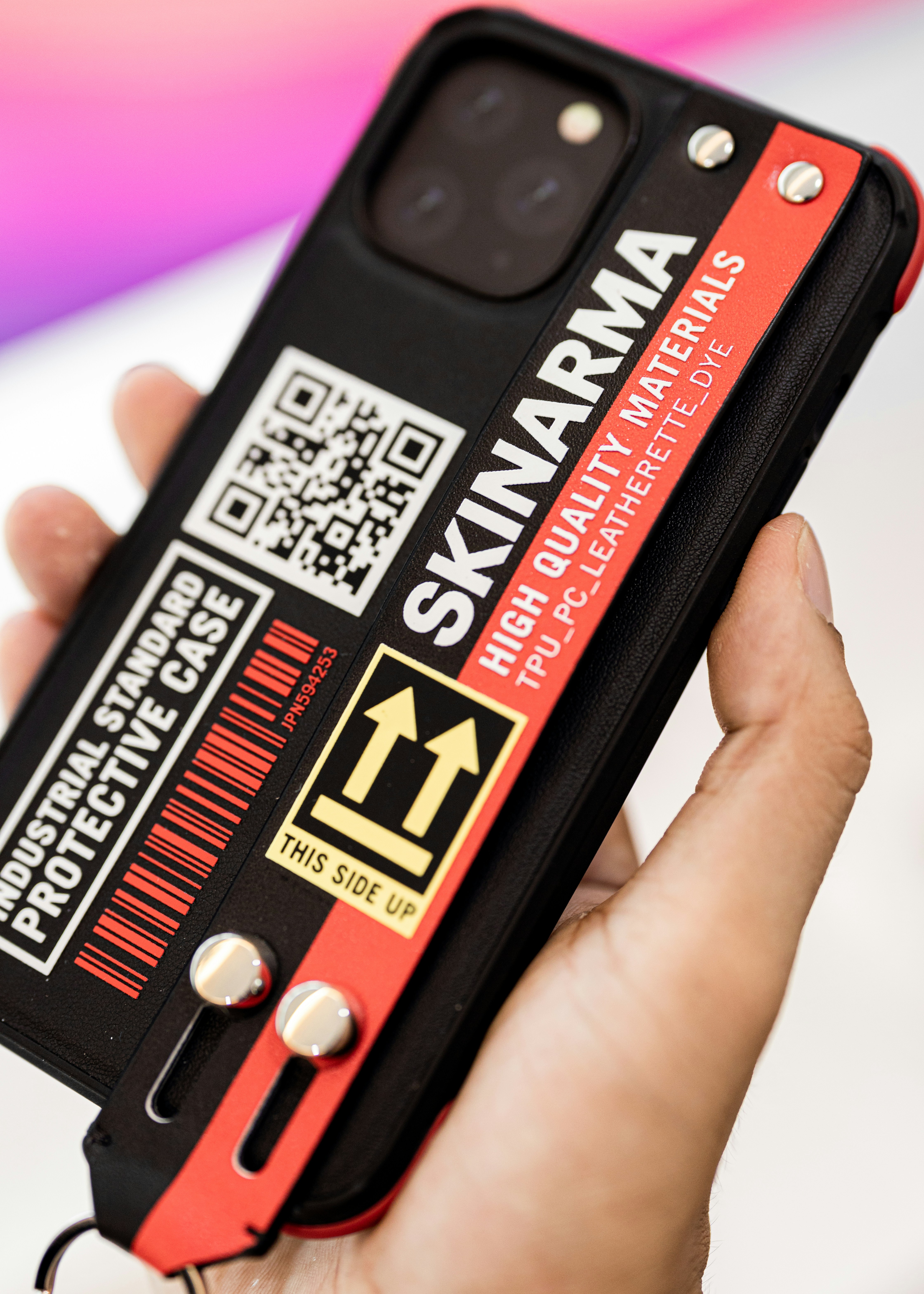 a person holding up a cell phone case