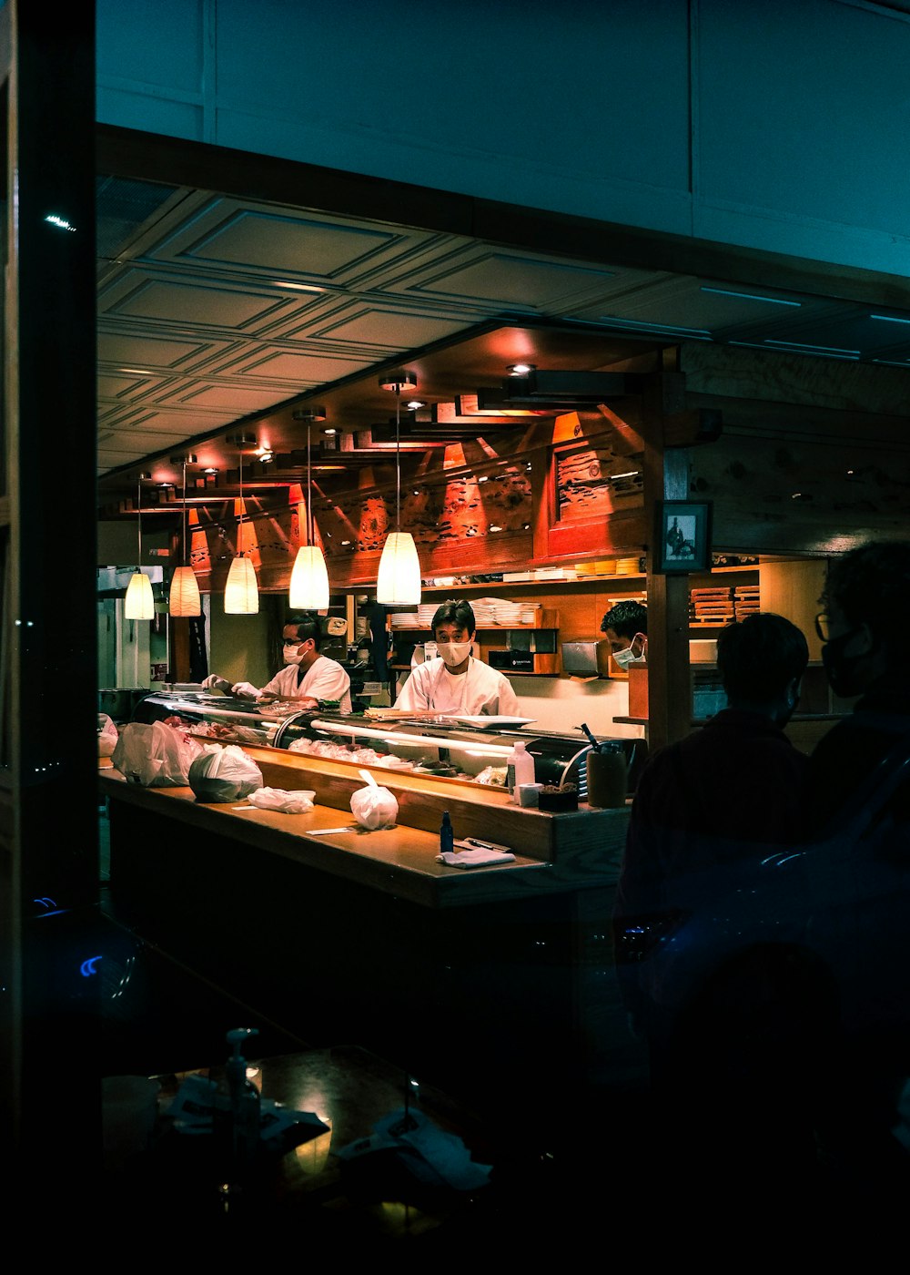 a group of people in a kitchen preparing food