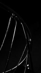 Close-up of a basketball hoop with a ball about to score, representing basketball betting options.