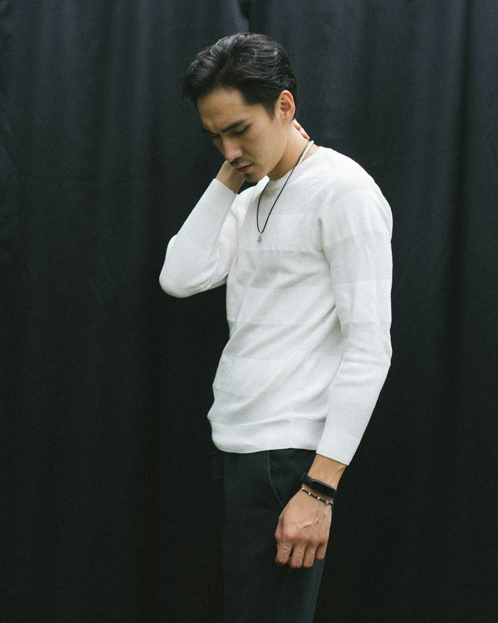 a man in a white shirt and black pants