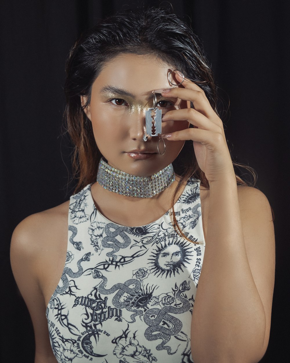 a woman in a white top holding a pair of scissors