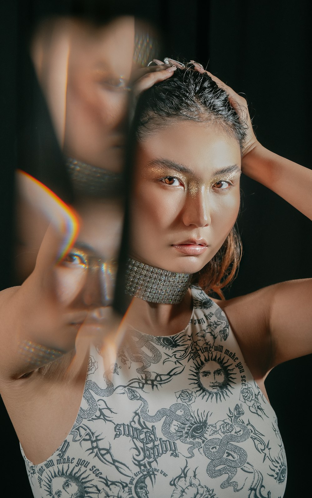 a woman is holding her hair in front of her face