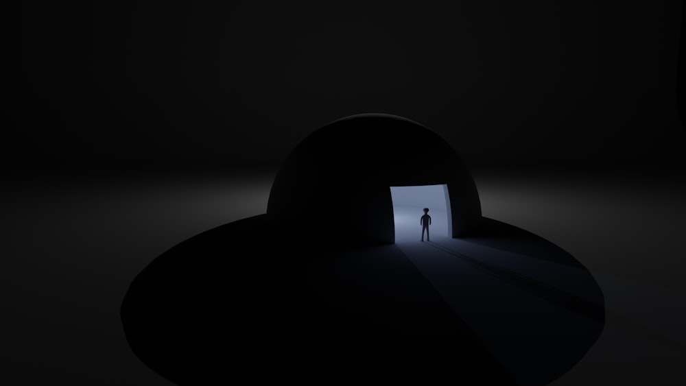 a person standing in a doorway in the dark