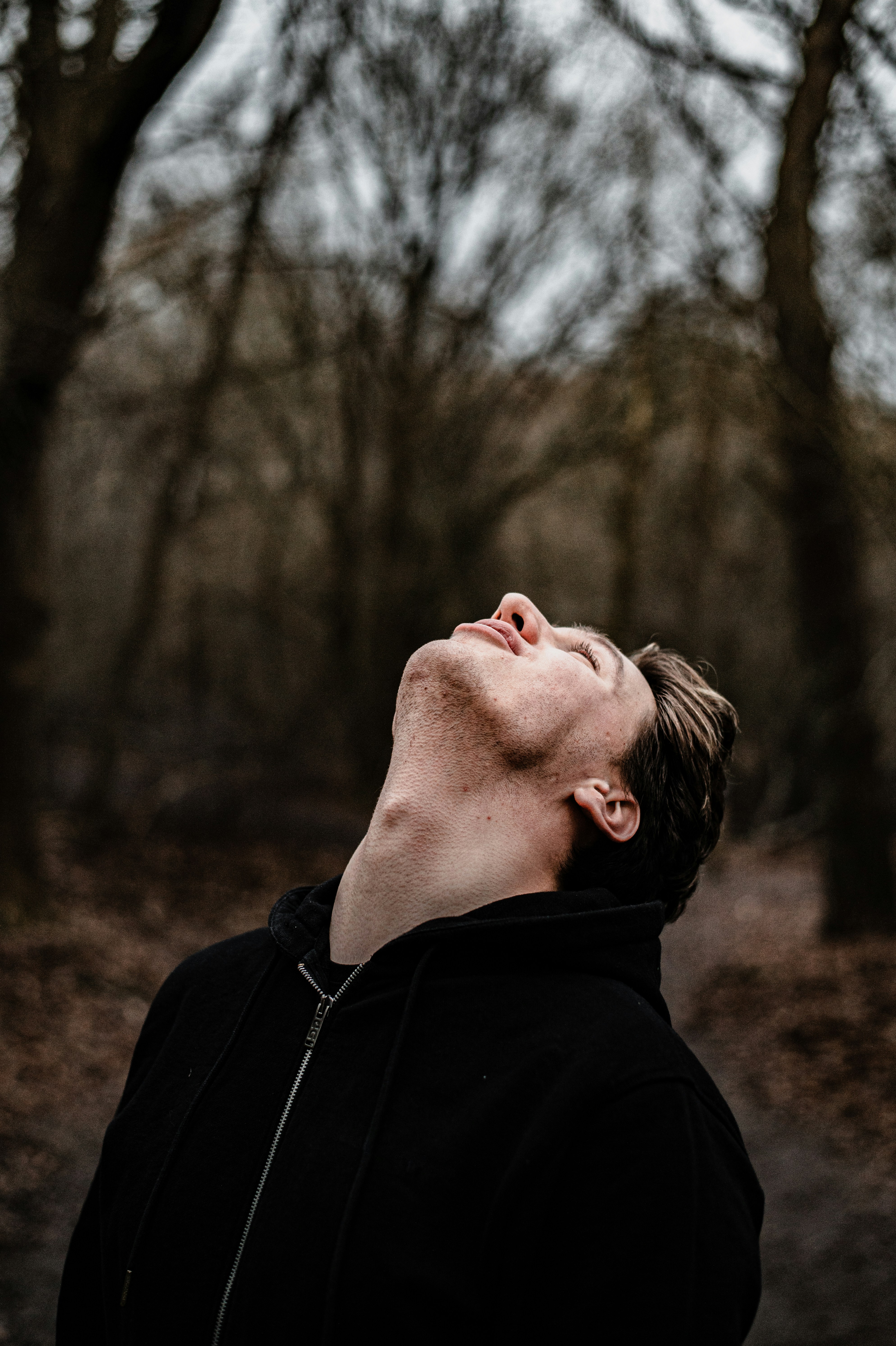 Un hombre parado frente a un árbol
