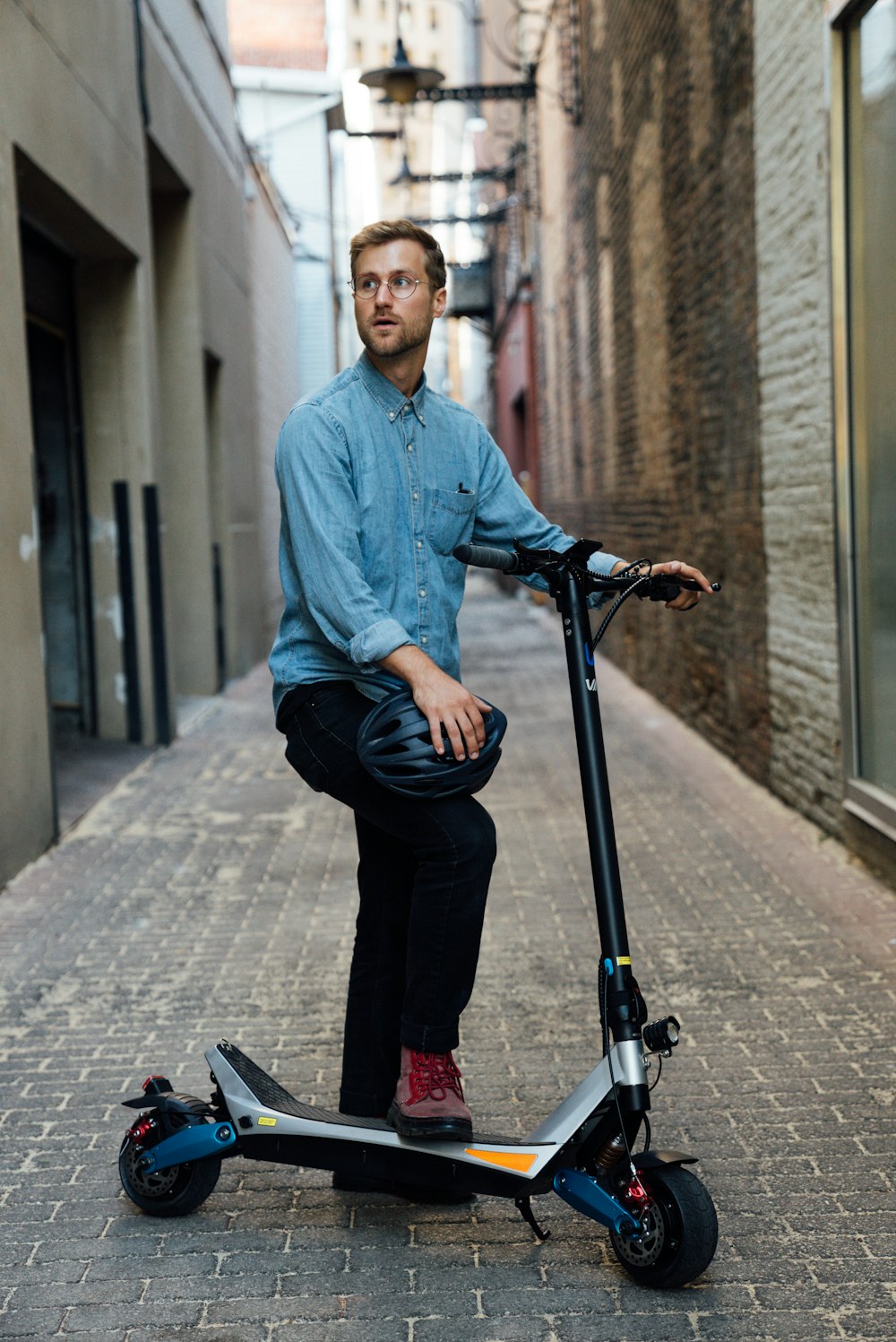 a man sitting on a scooter on a city street