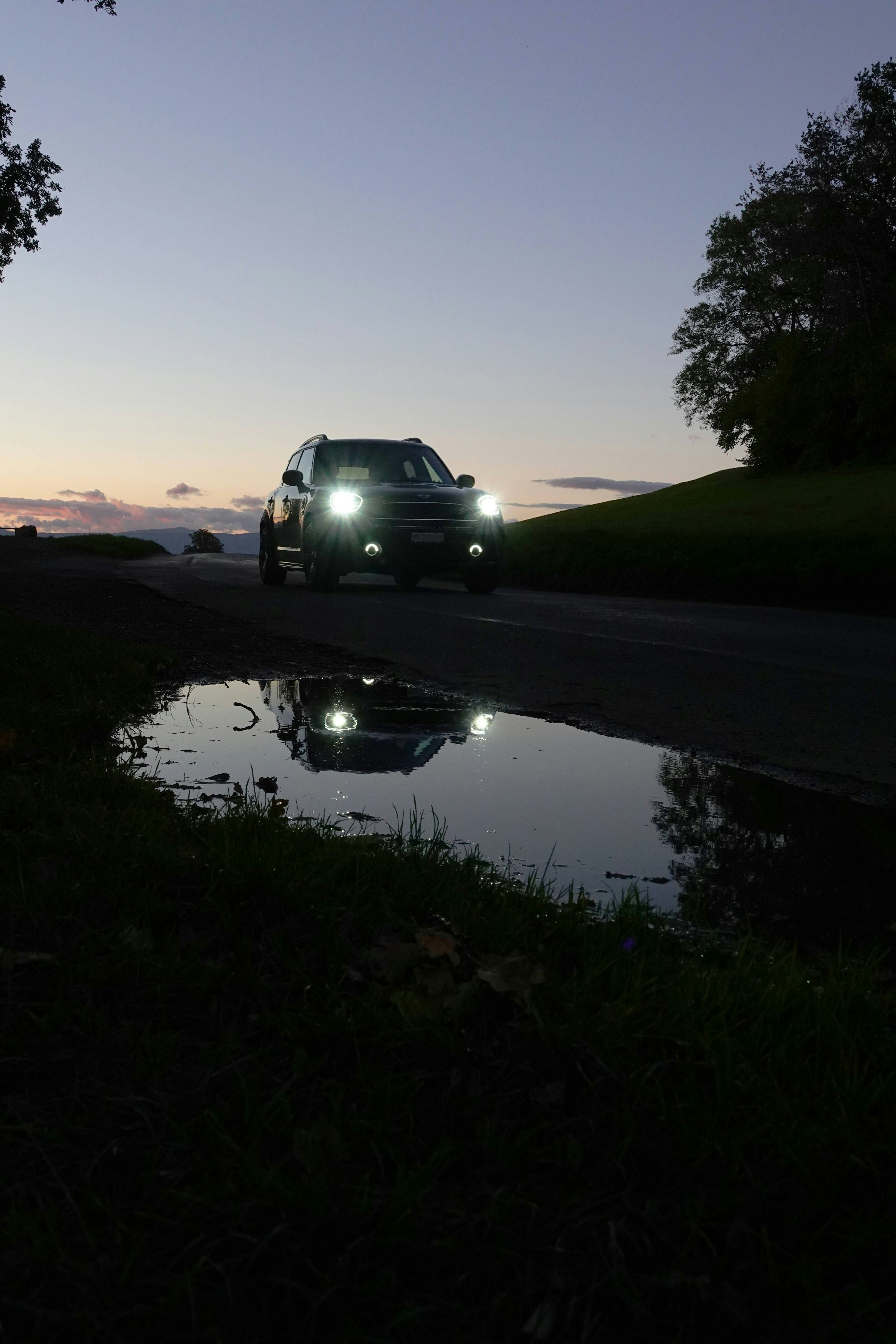 A car driving down a road at night photo – Free Lausanne Image on Unsplash