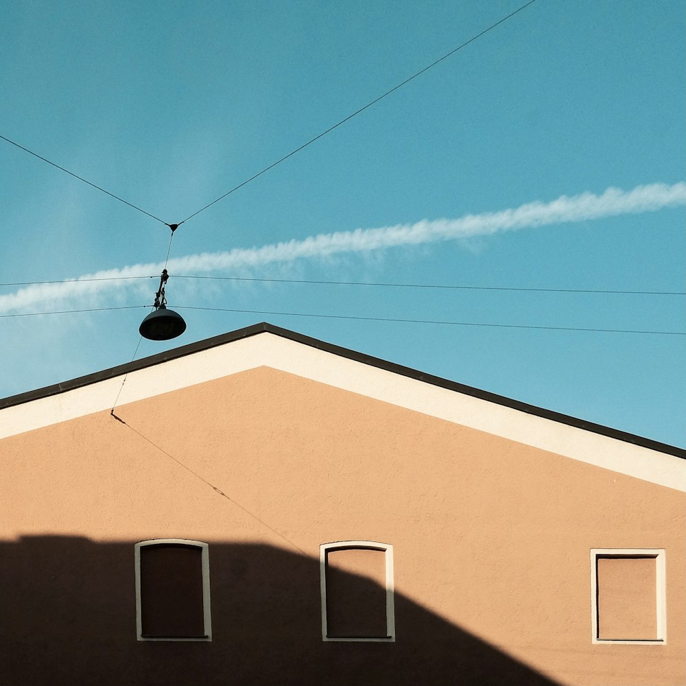a contrail is seen in the sky over a building