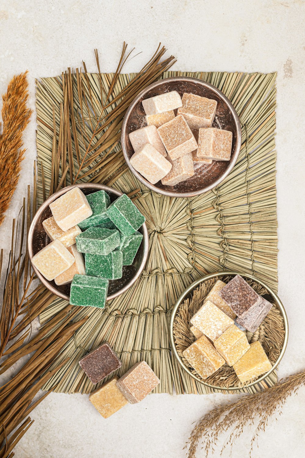 a table topped with bowls filled with different types of marshmallows