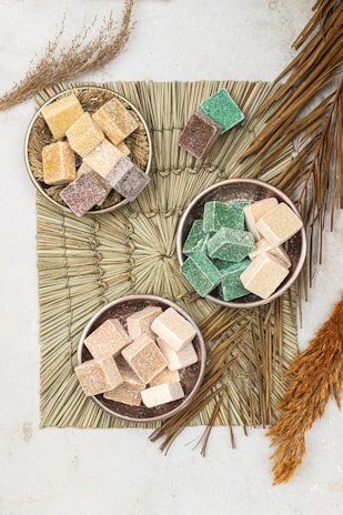 three bowls of marshmallows on a table