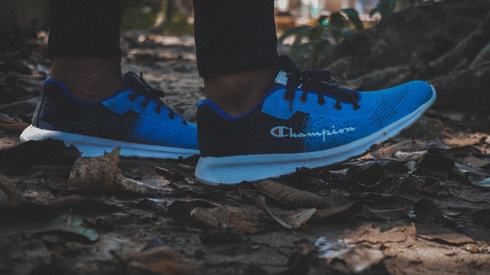 a close up of a person's feet wearing blue running shoes