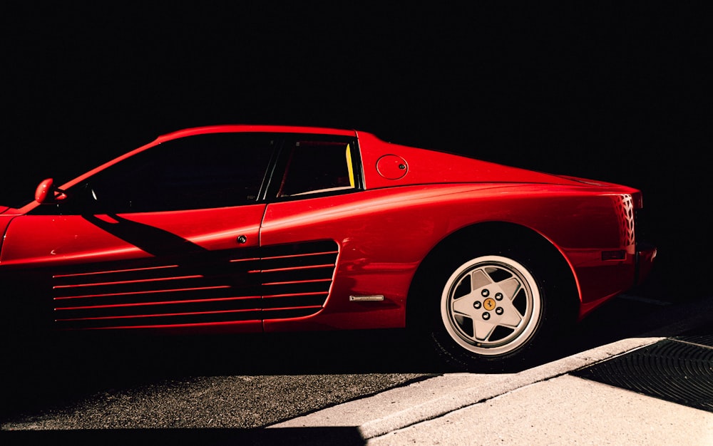 a red sports car parked on the side of the road