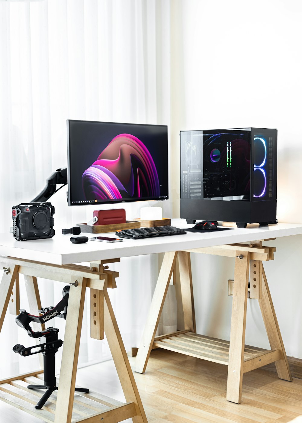 two computer monitors sitting on top of a white desk