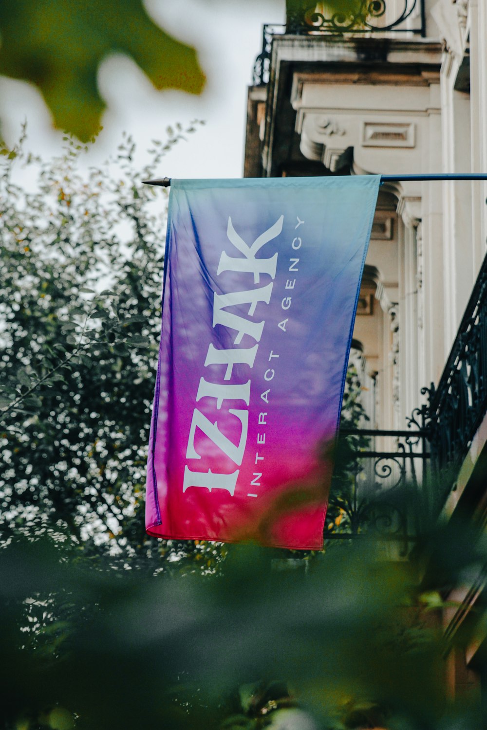 a purple and blue banner hanging from a balcony