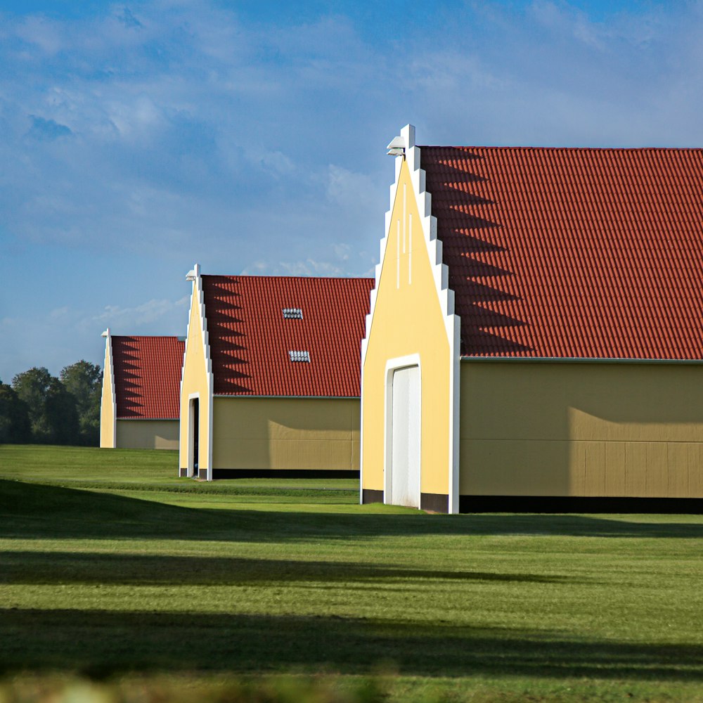 a row of yellow buildings with red roof tops