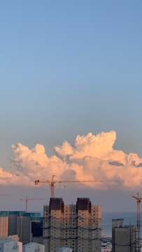 A skyline featuring modern steel buildings under construction.