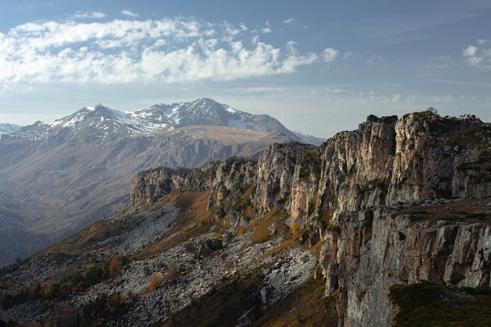 a view of a mountain range with snow capped mountains in the background