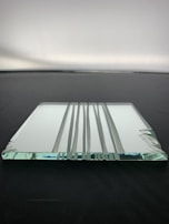 Close-up of a sturdy glazed glass panel with a subtle reflective finish highlighting craftsmanship.