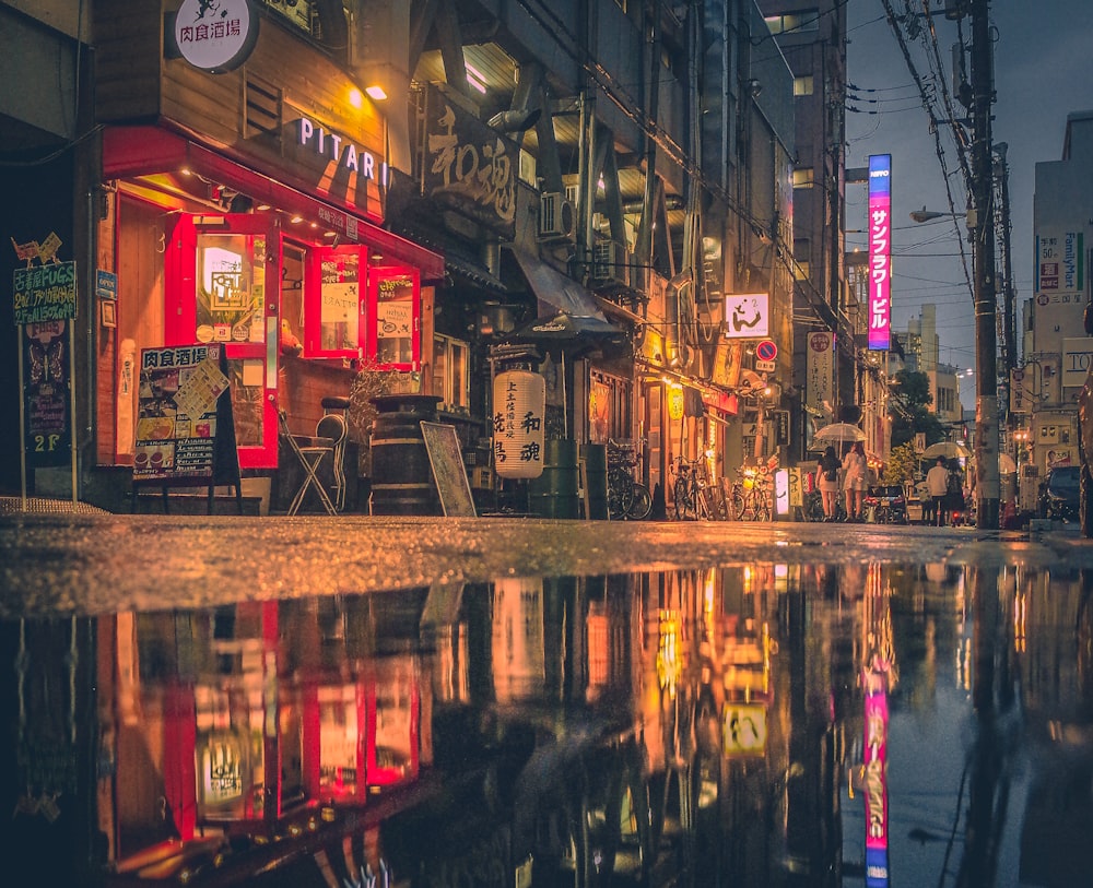 a city street with a puddle in the middle of it