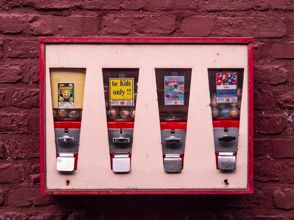 a red brick wall with a row of vending machines