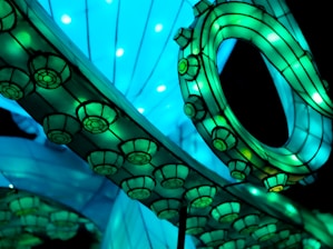 Close-up of a glowing, intricate 3D-printed structure against a dark background.