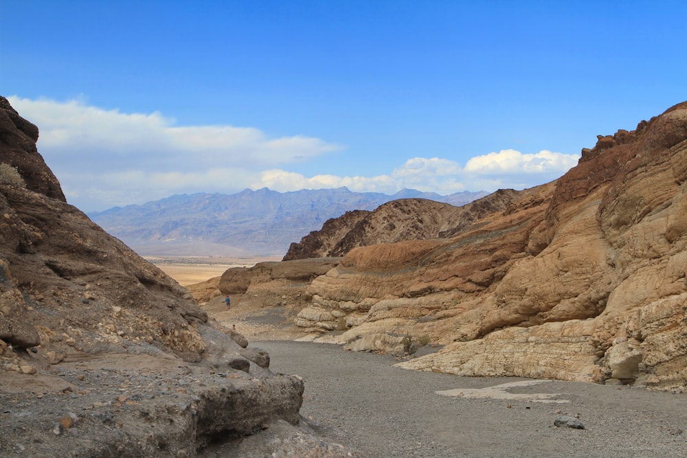 a narrow road in the middle of a desert